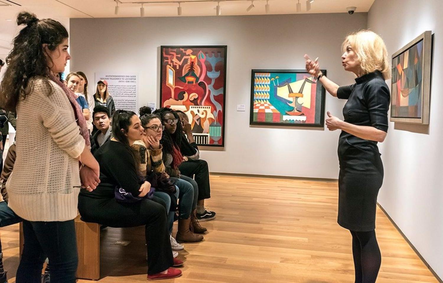 A lecturer speaking at the McMullen Museum of Art