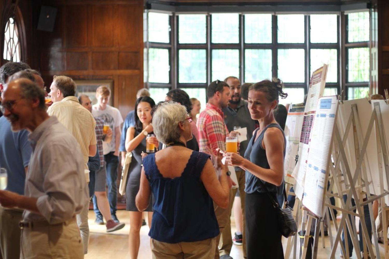 people talking around poster displays